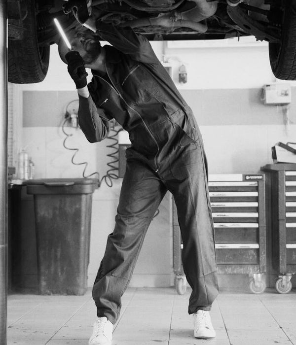 Experienced automotive technician analyzing vehicle data on professional diagnostic laptop