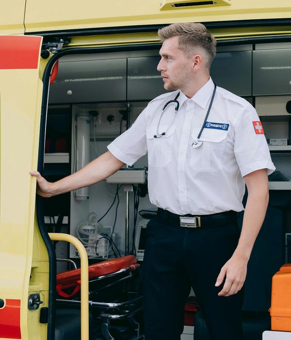 Experienced male automotive diagnostic specialist in professional service uniform