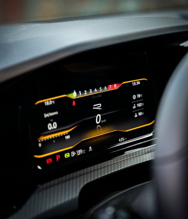 Modern vehicle dashboard displaying warning indicators and digital diagnostic screen