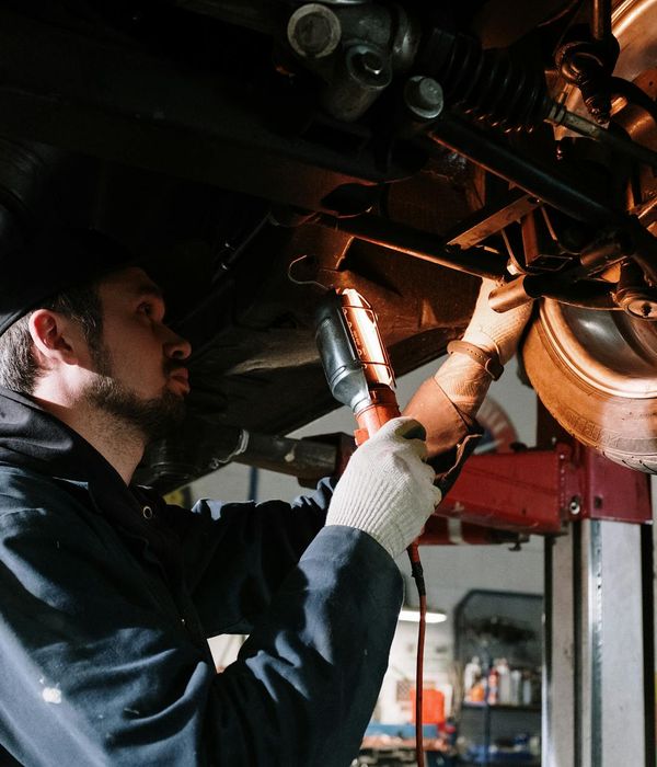 Skilled female automotive diagnostic engineer with modern equipment